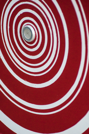 closeup of red and white alarm symbol in urban park