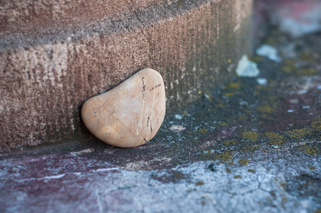 closeup of stone pebble in shaped heart on stoned wall in outdoor - Love conceptの写真素材