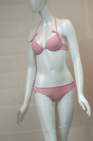 closeup of red stripped bikini on mannequin in fashion store showroom for womenの写真素材
