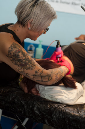 Illzach - France -9 June 2019 - Closeup of tattooing exhibition at fun car show eventのeditorial素材