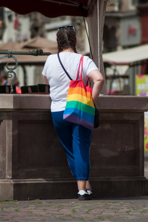 Mulhouse - France - 15 June 2019 - Portrait of lesbian woman standing in the street with rainbow bagのeditorial素材