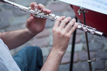 Closeup of hands on musician on flute  in tne streetの写真素材