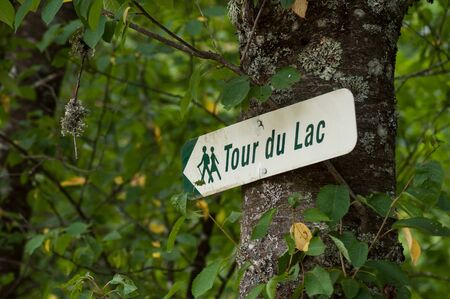 Closeup of information panel with french text : tour du lac, traductiob in english : lake tour