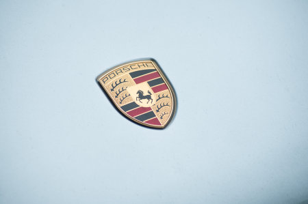 Mulhouse - France - 19 August 2019 - Closeup of Porsche logo on blue car front