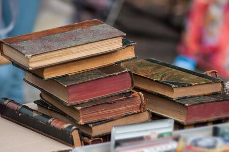 Closeup of old books at flea market in the street