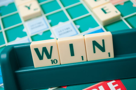 Mulhouse - France - 1 October 2019 - Closeup of plastic letters on Scrabble board game forming the...