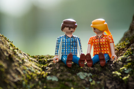 Mulhouse - France - 12 October 2019 - Closeup of PLaymobil characters sitting on tree trunk  in outdoorのeditorial素材