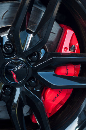 Mulhouse - France - 13 October 2019 - Closeup of red brake on black wheel of Chevrolet Corvette car parked in the streetのeditorial素材