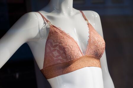 closeup of orange color bra on mannequin in fashion store showroom for womenの写真素材