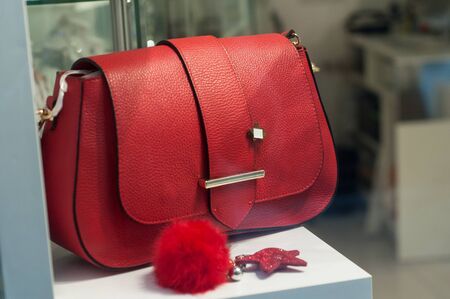 Closeup of red leather handbag in fashion store showroomの写真素材