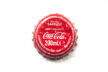 Mulhouse - France - 24 October 2019 - Closeup of drops of water on Cocacola capsule on white background on top viewのeditorial素材