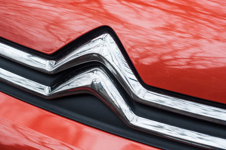 Mulhouse - France - 8 November 2019 - Closeup of Citroen logo on orange car front parked in the streetのeditorial素材
