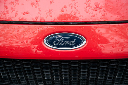 Mulhouse - France - 8 November 2019 - Closeup of rain drops on red Ford car front parked in the streetのeditorial素材