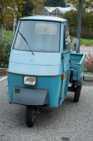 Mulhouse - France - 10 November 2019 - Front view of blue vintage piaggio tricycle parked in the...