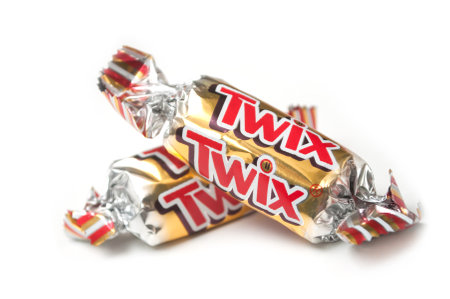 Mulhouse - France - 26 November 2019 - Closeup of Twix chocolate bar by Mars compagny in golden packaging on white backgroundのeditorial素材