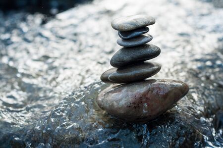Closeup of stone balance on rocks in the riverの写真素材