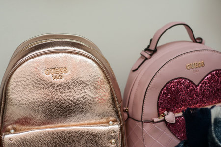 Mulhouse - France - 8 December 2019 - Closeup of luxury backbag for kids by Guess in a fashion store showroomのeditorial素材