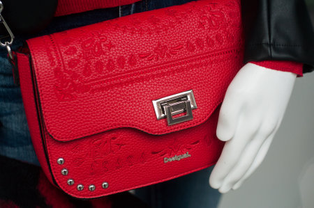 Mulhouse - France - 8 December 2019 - Closeup of red leather handbag by Desigual in a luxury fashion store showroomのeditorial素材
