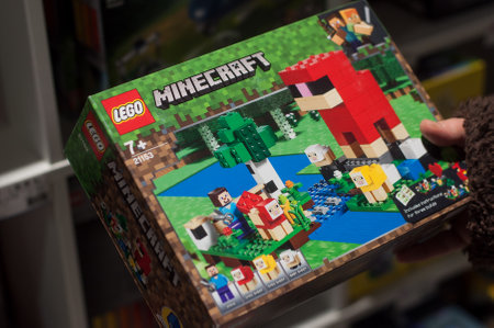 Mulhouse - France - 7 December 2019 - Closeup of Yellow lego box minecraft in hand of woman in a toy...