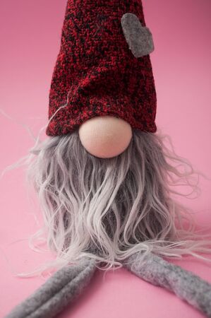 Closeup of christmas leprechaun on pink background の写真素材