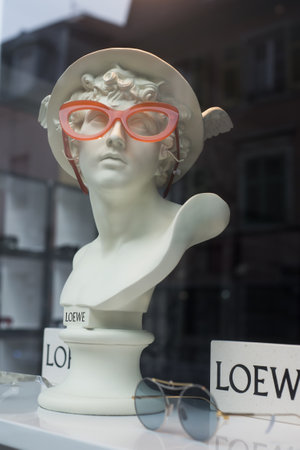 Mulhouse - France - 29 December 2019 - Closeup of eyeglasses presentaion on statue by Loewe in optician  store showroomのeditorial素材