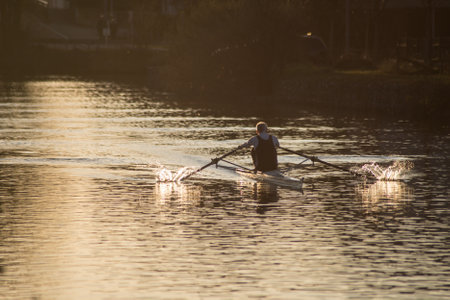 Mulhouse - France - 16 January 2020 - portrait on back view of old man  rowing on the riverのeditorial素材