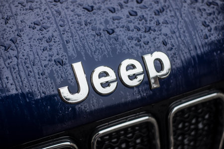 Mulhouse - France - 2 February 2020 - closeup of rain drops on Jeep logo on blue car parked in the streetのeditorial素材