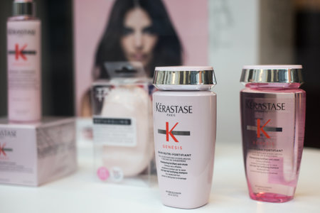 Mulhouse - France - 2 February 2020 - Closeup of pink shampoo and lotion bottles by Kerastase brand in a hirdresser sstore showroomのeditorial素材