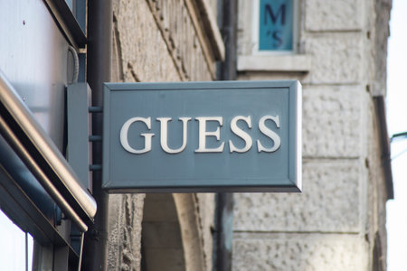 Basel - Switzerland - 7 February 2020 - Closeup of Guess logo on signboard on luxury fashion store front in the streetのeditorial素材