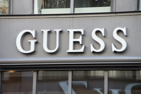 Basel - Switzerland - 7 February 2020 - Closeup of Guess logo on signboard on luxury fashion store front in the streetのeditorial素材