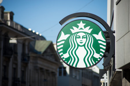 Basel - Switzerland - 7 February 2020 - Closeup of Starbucks logo on signboard on fast food front in the streetのeditorial素材
