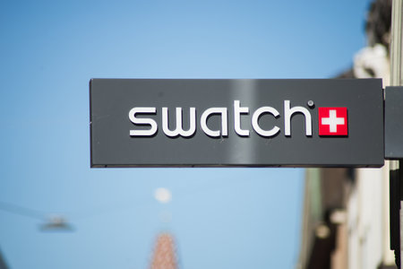 Basel - Switzerland - 7 February 2020 - Closeup of Swatch logo on signboard on store front in the streetのeditorial素材