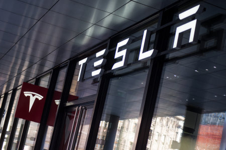 Basel - Switzerland - 7 February 2020 - Closeup of Tesla logo on car retailer front  in the cityのeditorial素材