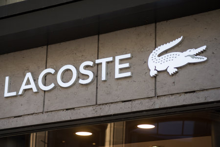 Basel - Switzerland - 7 February 2020 - Closeup of Lacoste logo on fashion store front in the street