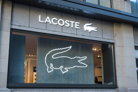 Basel - Switzerland - 7 February 2020 - Closeup of Lacoste logo on fashion store front in the streetのeditorial素材