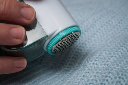Closeup of balls shaving on blue woolen pulloverの写真素材