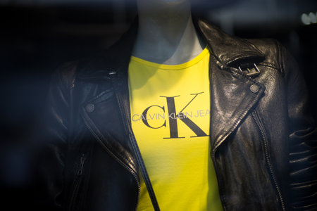 Mulhouse - France - 1 March 2020 - Closeup of yellow tee shirt by Calvin Klein on mannequin in a fashion store showroomのeditorial素材