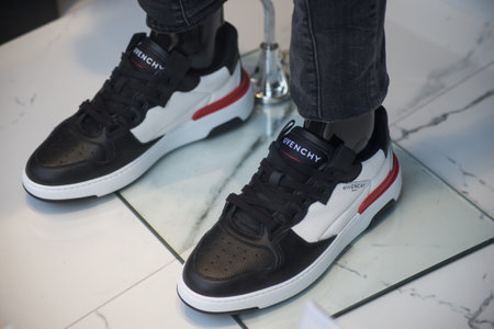 Mulhouse - France - 1 March 2020 - Closeup of black and white leather sneakers by Givenchy in a fashion store showroomのeditorial素材