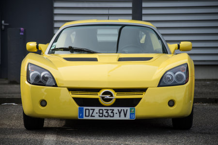 Mulhouse - France - 8 Mars 2020 - Front view of yellow Opel Speedster roadster  of parked in the streetのeditorial素材