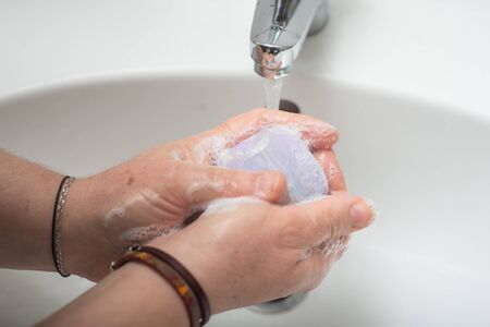 Closeup of hands of woman washing hands to protect against virusの写真素材