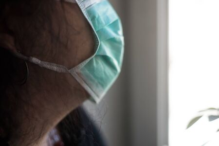 Closeup of woman wearing a medical mask to protect against the corona virus