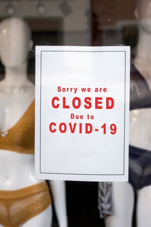 Closeup of information sign on the window of the underwear store front : Sorry we are Closed due to covid-19の写真素材