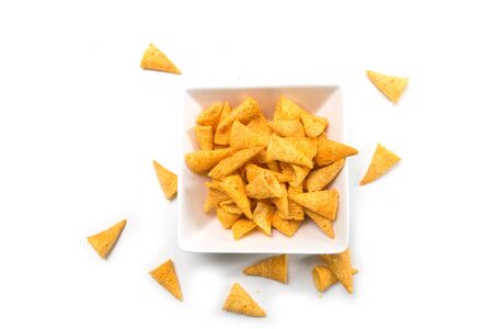 Closeup of bugles salted appetizers in a white bowl on top view on white backgroundの写真素材