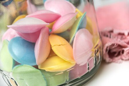 closeup of pastel flying saucers in a glass container 