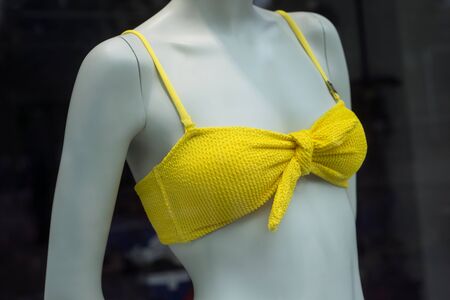 closeup of Yellow bikini on mannequin in fashion store showroom for womenの写真素材