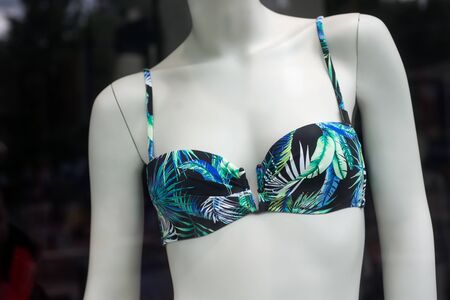 closeup of blue and green bikini on mannequin in fashion store showroom for womenの写真素材