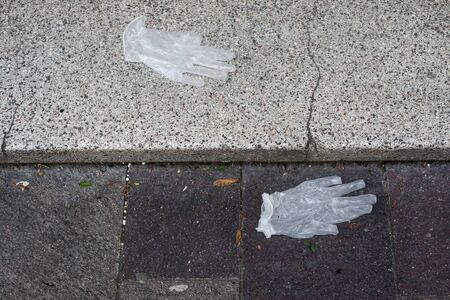 Closeup of used latex gloves abandoned in the street の写真素材
