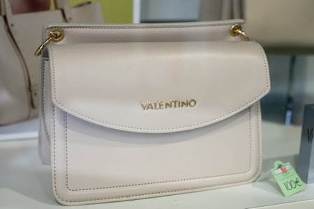 Mulhouse - France - 22 May 2020 - Closeup of beige leather handbag by Valentino in a luxury fashion stoneのeditorial素材