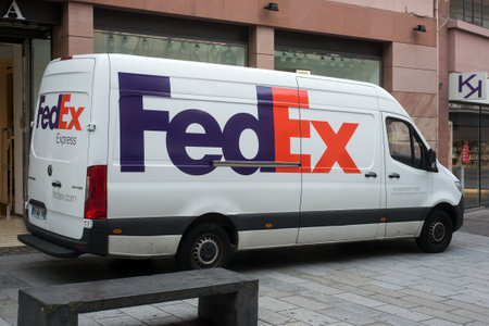 Mulhouse - France - 23 May 2020 - Fedex delivery truck parked in the street near fashion store