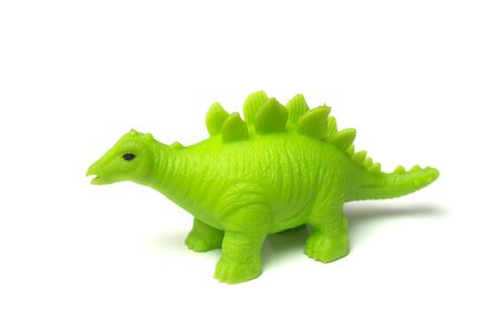 Closeup of green plastic dinosaur toy on white backgroundの写真素材